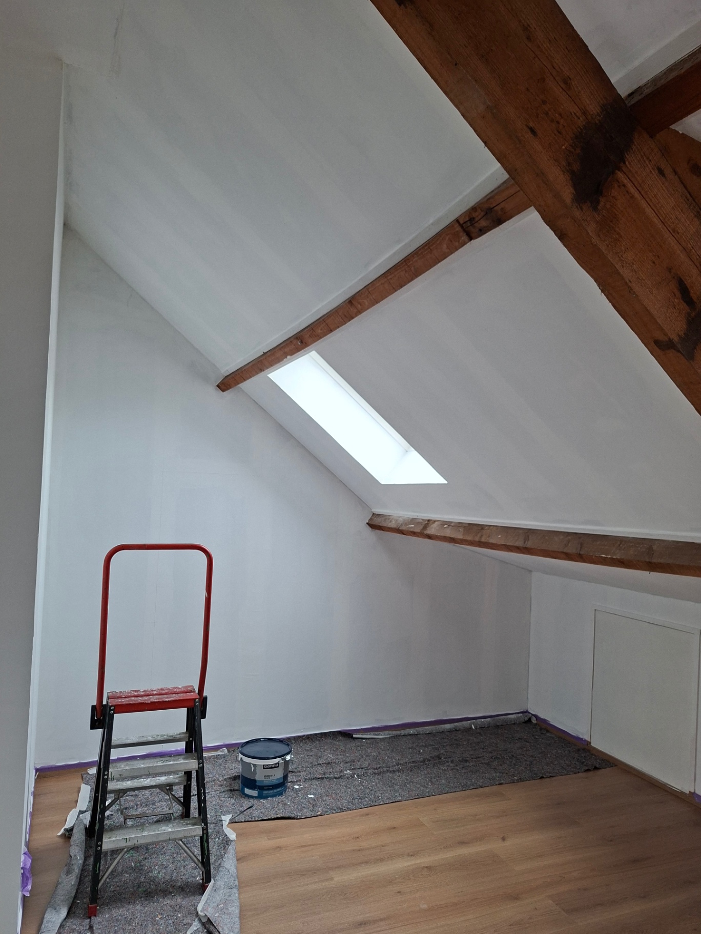 Zolder na schilderwerken met witte wanden